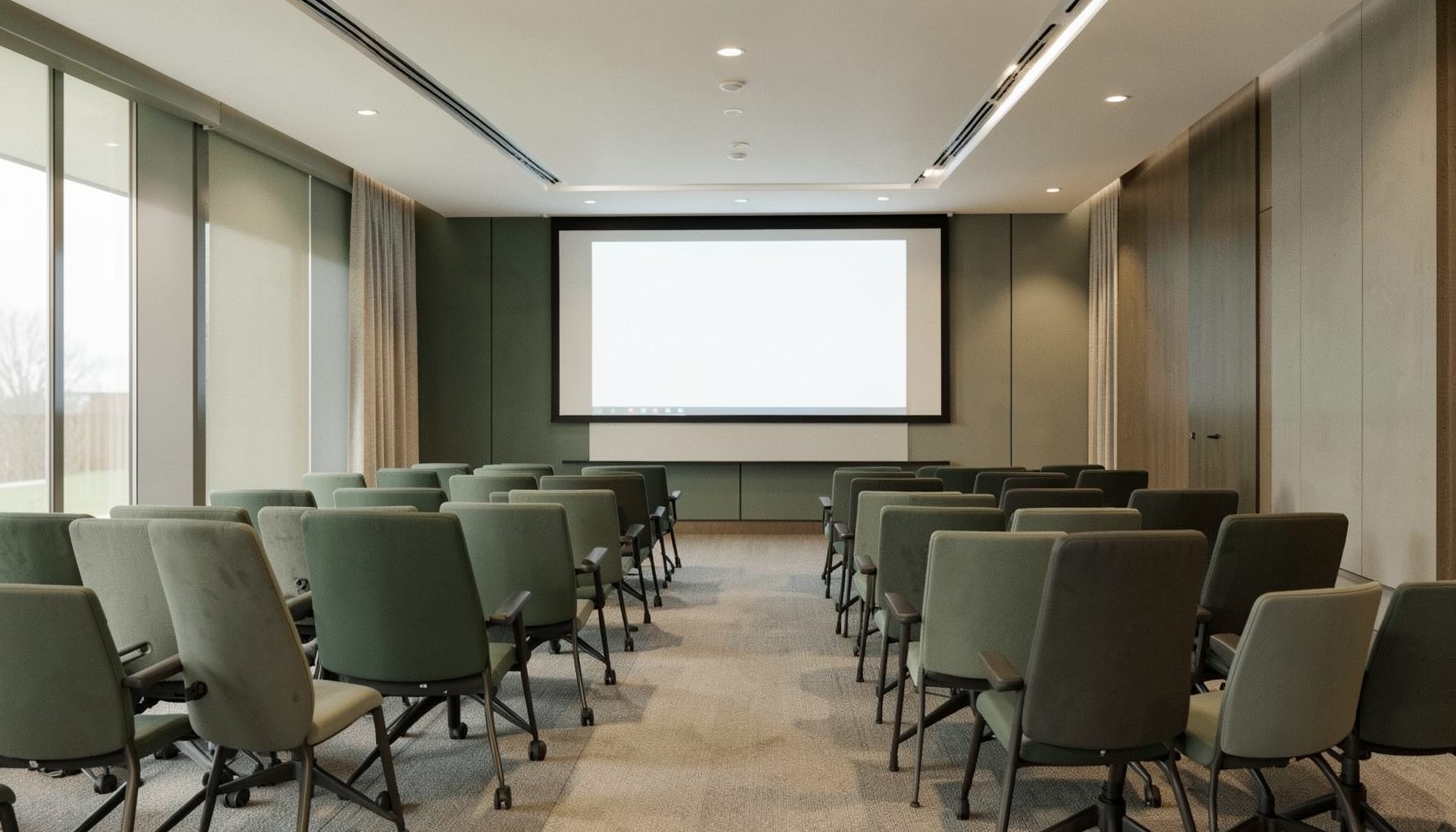 Softly lit professional meeting space with rows of chairs and a presentation screen, warm neutral tones